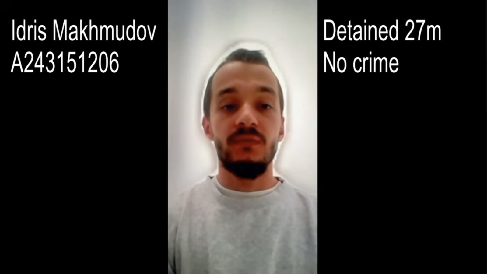 Video still of Idris Makhmudov, who has short dark hair and a beard. On-screen text reads: “Idris Makhmudov, A243151206. Detained 27m. No crime.”